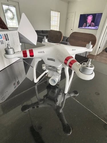 White DJI Phantom 3 Standard quadcopter drone with red stripe arms
