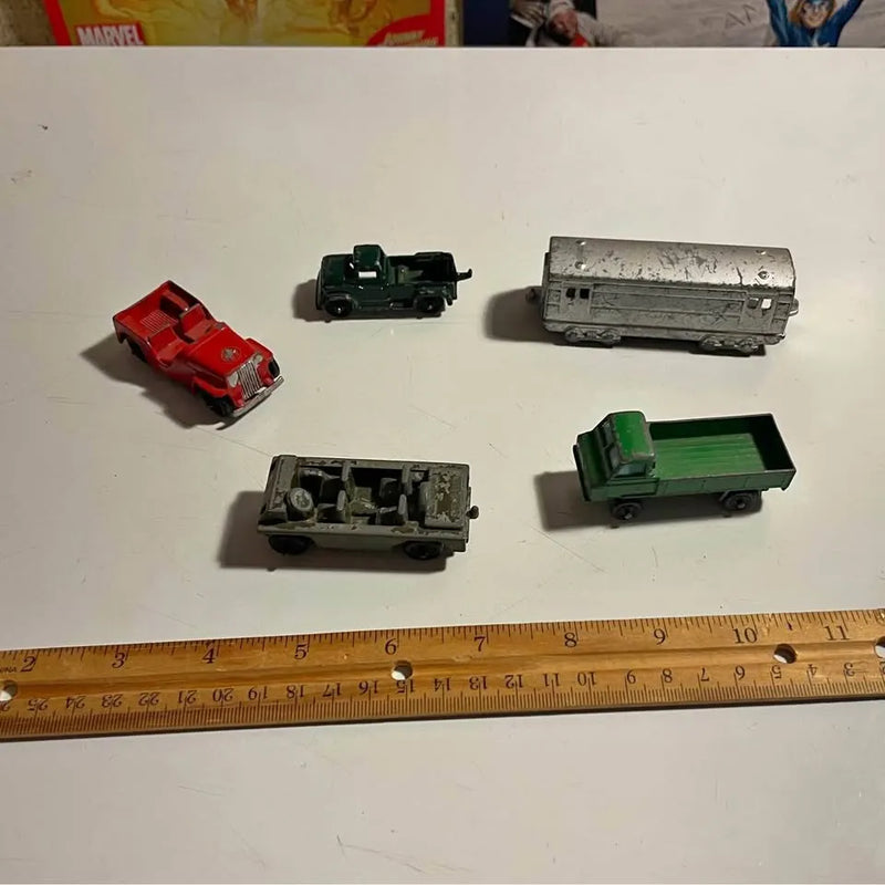 Diecast car lot with red, black, silver, gray and green vehicles