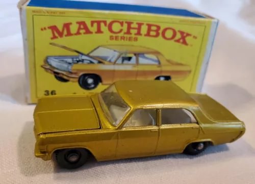 Yellow 1:64 diecast car model with open door and Matchbox Series box