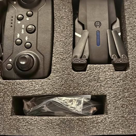 Drone controller and wrapped spare parts in molded box tray