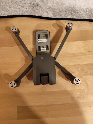 Broken quadcopter drone body with four prop arms, parts-only