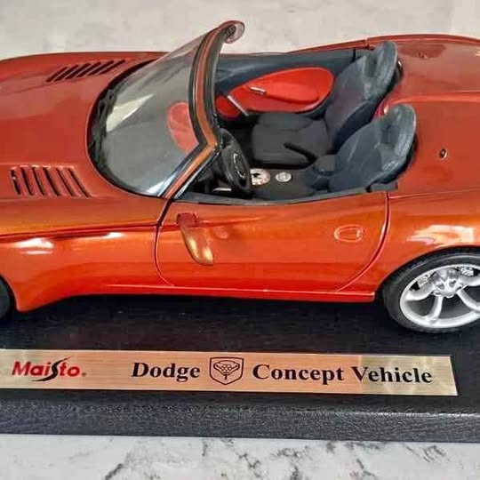 Orange 1:18 die-cast Dodge concept car with open driver-side door