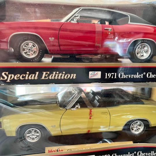Diecast model car display with red and yellow classic cars in blister packaging