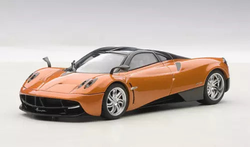 Orange bronze diecast sports car model with black front splitter and silver wheels