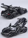 Metal diecast model car, dark metallic black, open hood with detailed engine