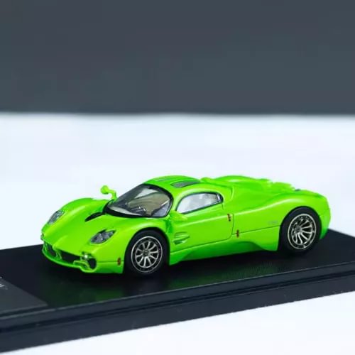 Green 1/64 scale diecast sports car model with open wheels and black roof
