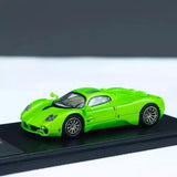 Green 1/64 scale diecast sports car model with open wheels and black roof