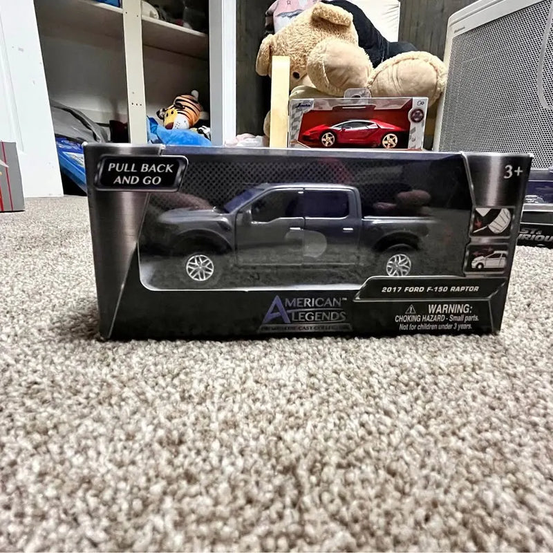 Raptor diecast truck in retail display box with pull-back and go label