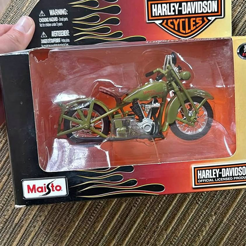 Diecast replica motorcycle in retail box, green bike in clear blister with logos