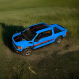 Blue diecast toy truck with black hood, detailed interior, and alloy-style wheels