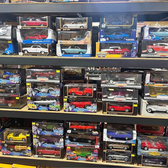 1:18 scale diecast car lot, boxed vehicles on store shelf