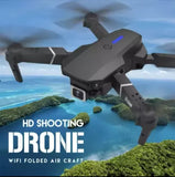 Foldable quadcopter drone with wide-angle camera, dark gray body and propellers