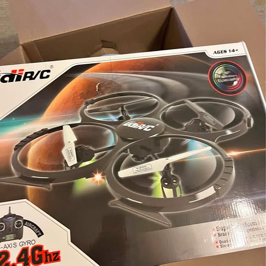RC quadcopter drone with propellers, orange and gray, in retail box, 2.4GHz