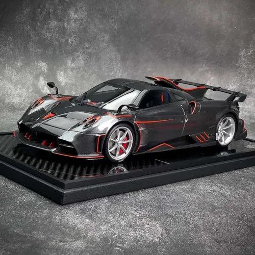 1/18 diecast model car, black and silver with red stripes, on display base