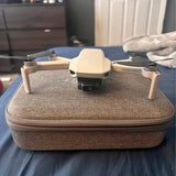 DJI Mavic Mini drone with light body on textured gray carrying case