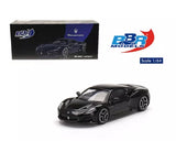 Black Maserati MC20 1:64 diecast model car, front three-quarter view with wheels