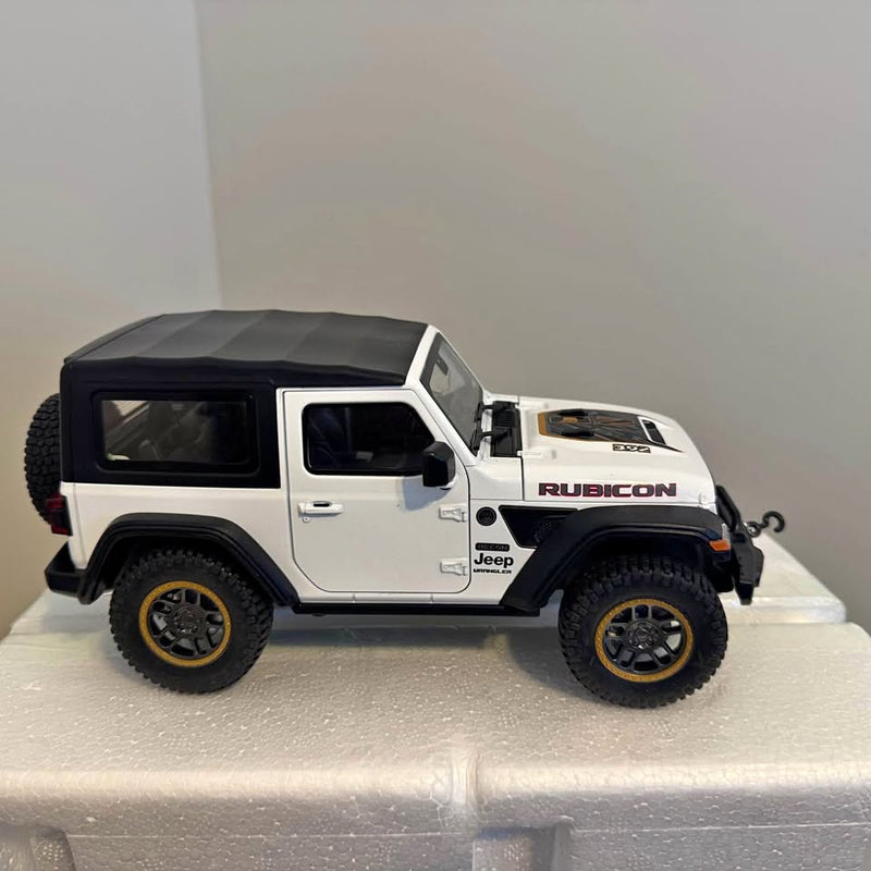 Metal diecast Jeep Rubicon toy truck, white and black, side view with detailed wheels