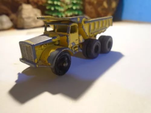 Diecast dump truck model with yellow cab and dark wheels, HO scale Euclid style