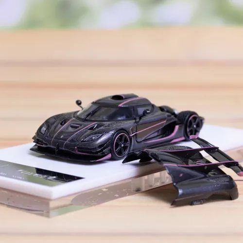 1/64 diecast sports car model, black with pink accents, front and side view