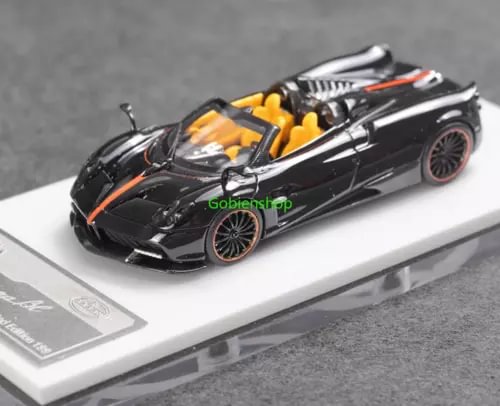 Black convertible sports diecast car model with yellow flame accents, on base.
