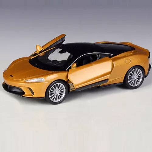 McLaren GT gold alloy diecast model car, front three-quarter view, silver wheels