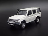 1/64 scale diecast model car of Toyota Land Cruiser 70, white SUV, front 3/4 view