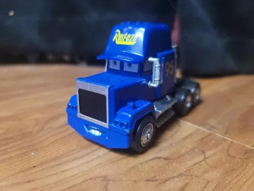Blue diecast semi truck cab, Mack Rust-eze style, front 3/4 view