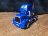 Blue diecast semi truck cab, Mack Rust-eze style, front 3/4 view