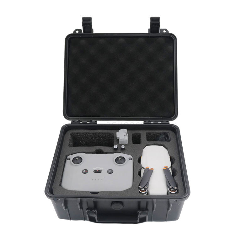 Hard case drone storage box with foam insert, open lid, holding a gray quadcopter