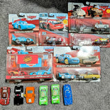 Diecast toy cars in blister packaging, with race-themed designs and cars inside