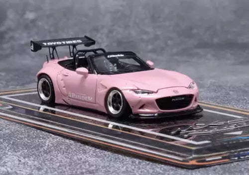 Pink convertible diecast roadster car model with black rear spoiler and wheels