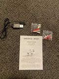 Drone battery charger with USB cable, propeller packs, and instruction sheet