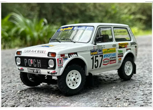 White rally diecast model car with number 15 decals, front three-quarter view