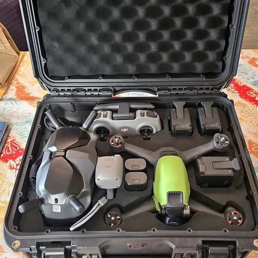 DJI FPV drone kit in molded hard case with drone, goggles and controllers