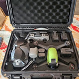 DJI FPV drone kit in molded hard case with drone, goggles and controllers