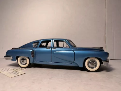 Franklin Mint diecast model car, blue 1948 Tucker Torpedo, 1:24, side view