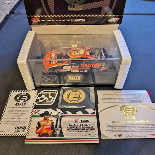 Orange NASCAR diecast race car in clear display box with Elite branding