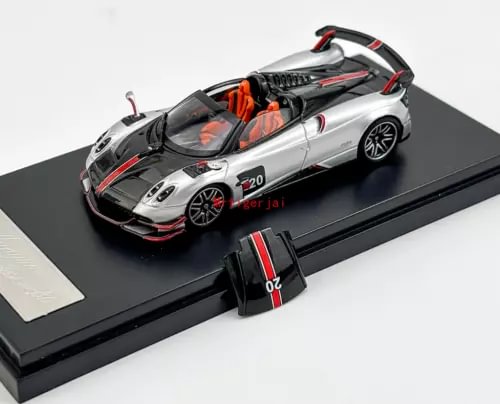 Silver sports car diecast model on display base, black hood and red accents.