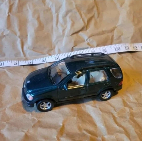 KINSMART BMW 1/36 diecast car toy, dark green hatchback, side view
