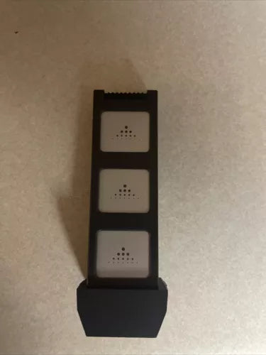 Black RC drone remote controller with three button sections and speaker openings