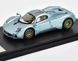 Ice blue 1:64 racing sports diecast model car with gold wheels on display base