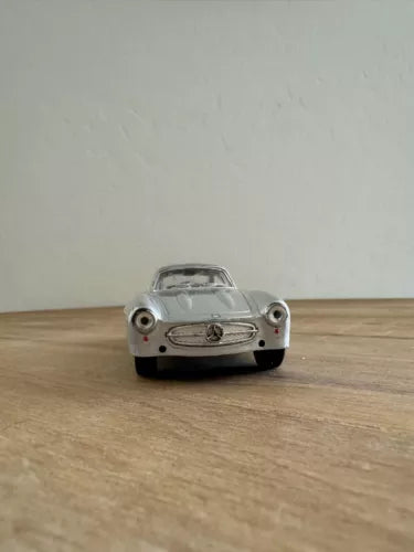 Silver 1954 diecast coupe model toy car, front view with grille and headlights
