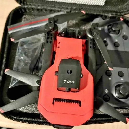 Orange drone camera module with black housing, ports, and connector cutout