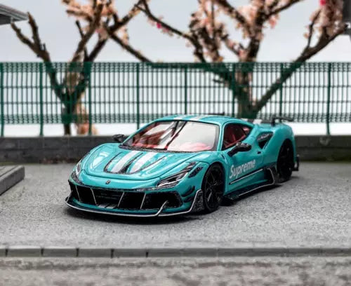 Teal sports diecast car model with black wheels and racing stripe detail, front view