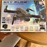 Black drone on product box with propellers and camera features icons