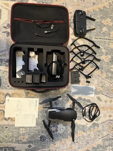 Drone bundle hard case with drone, batteries, charger cables, prop guards