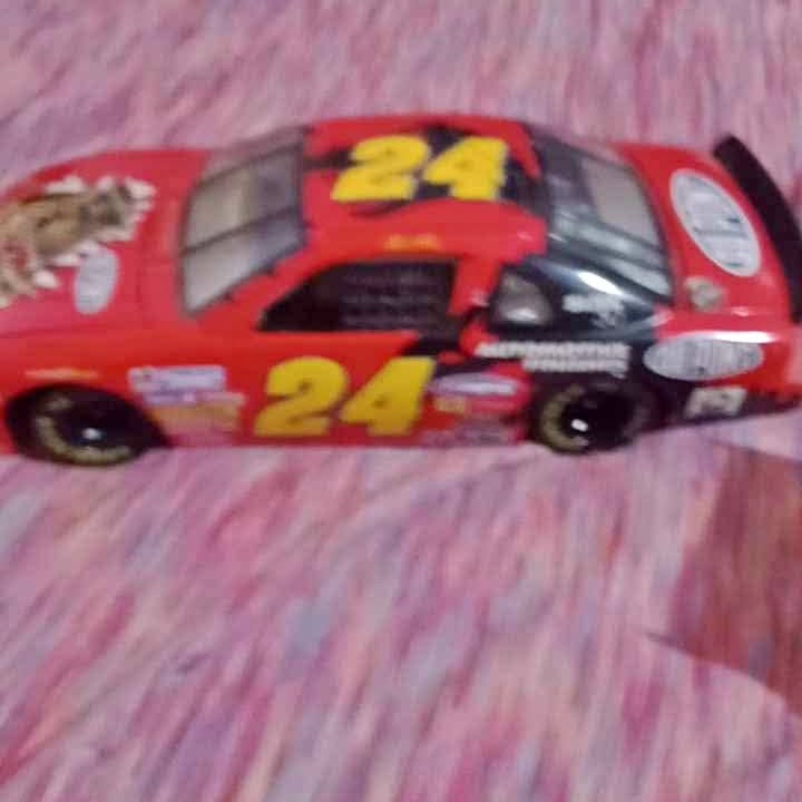 Red diecast race car with yellow 24 on the side, open cockpit and black tires