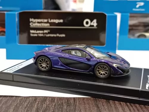 Purple diecast sports car model on black display base, side view