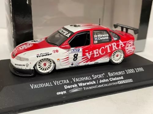 Diecast racing car model with red, white, and black Vectra livery, number 8