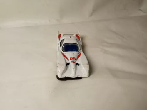 White diecast race car front view with blue and red accents, open wheels
